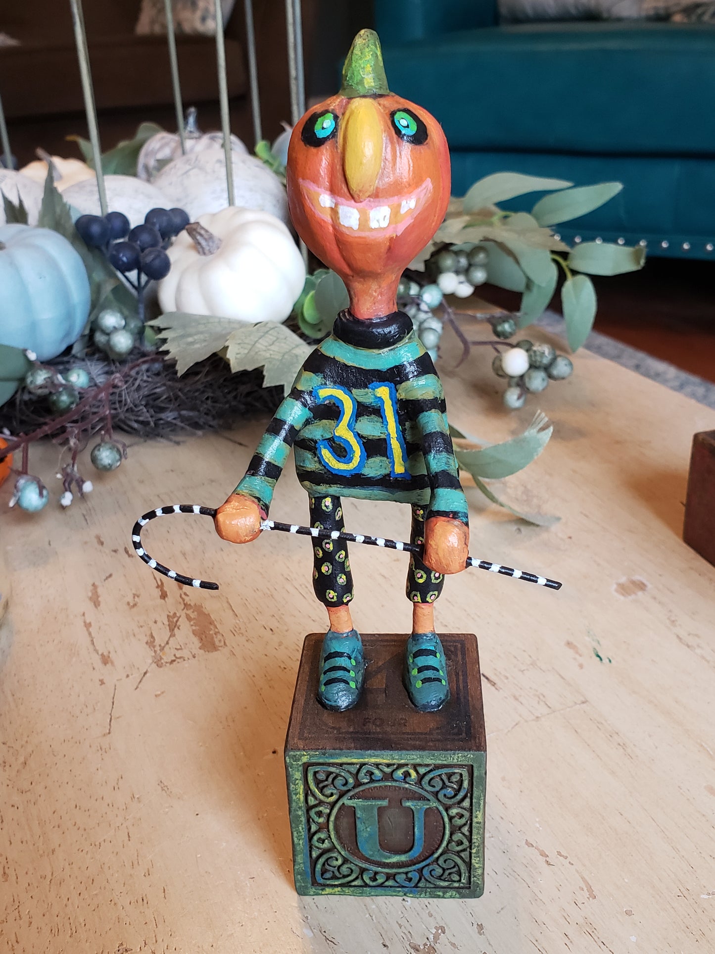 Paper clay Halloween character. A whimsical pumpkin head character holding a cane standing on a "lettered" childs wooden block. This lil' fella is sure to become one of your favorite pieces. Whimsical, unique and OOAK