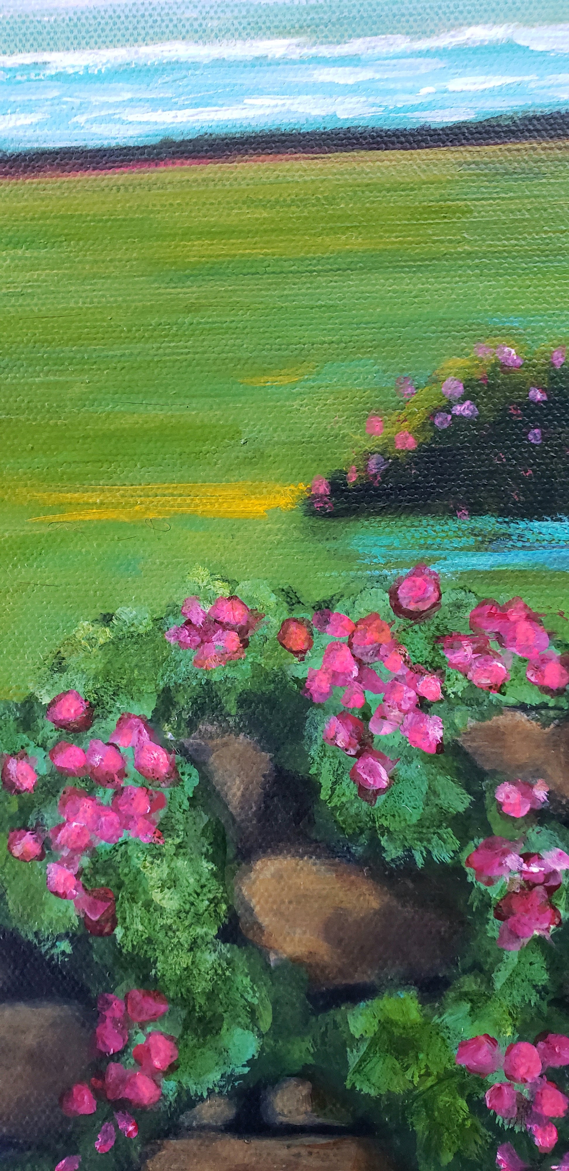 Artistic depiction of a field with pink flowers and green grass under a blue sky.