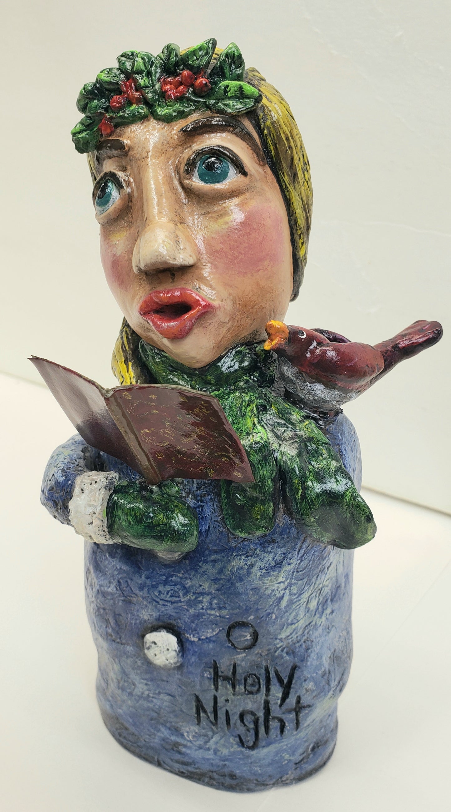 paper clay christmas carol doll holding a christmas carol book with a bird on her shoulder handmade christmas decoration