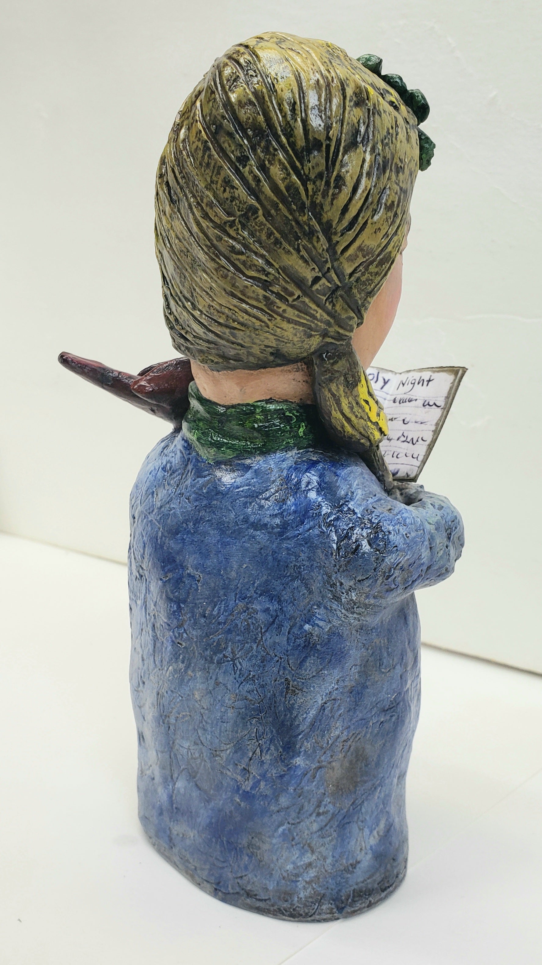 paper clay christmas carol doll holding a christmas carol book with a bird on her shoulder handmade christmas decoration