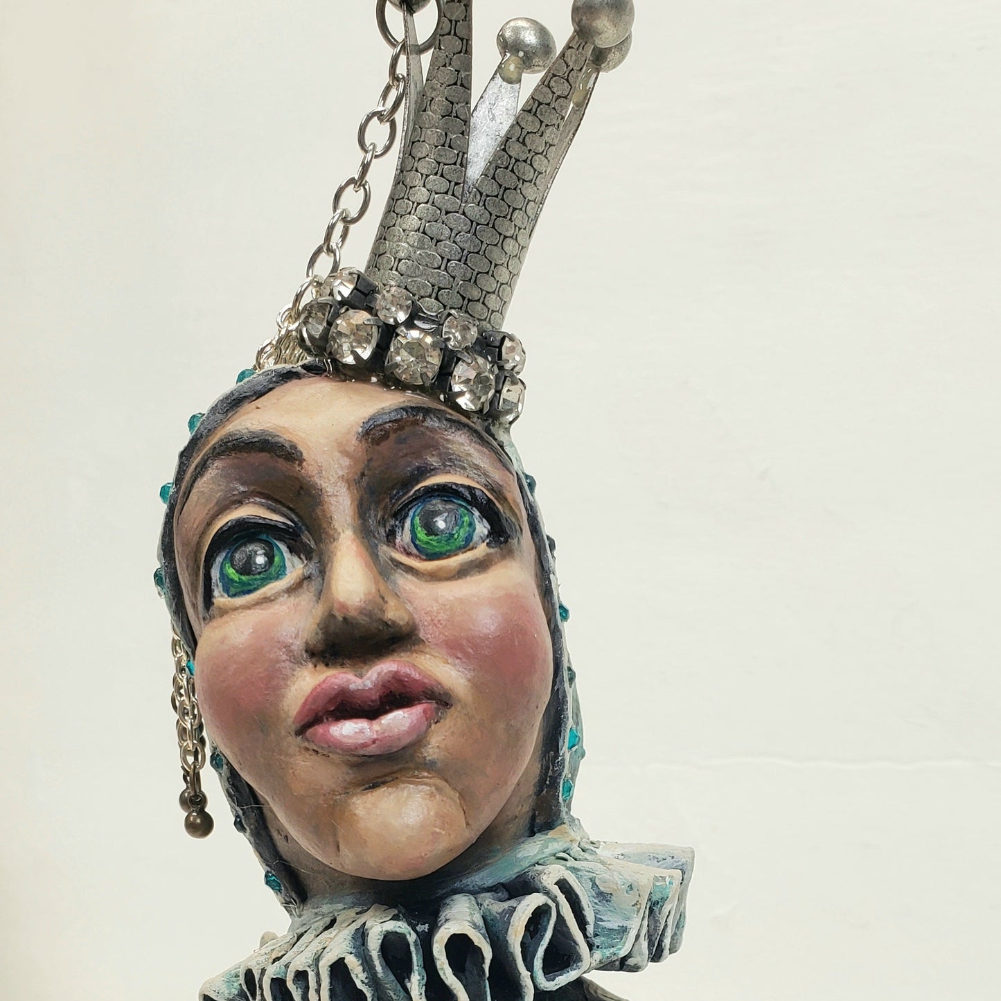 Jester figurine with a crown butterfly and patterned dress 