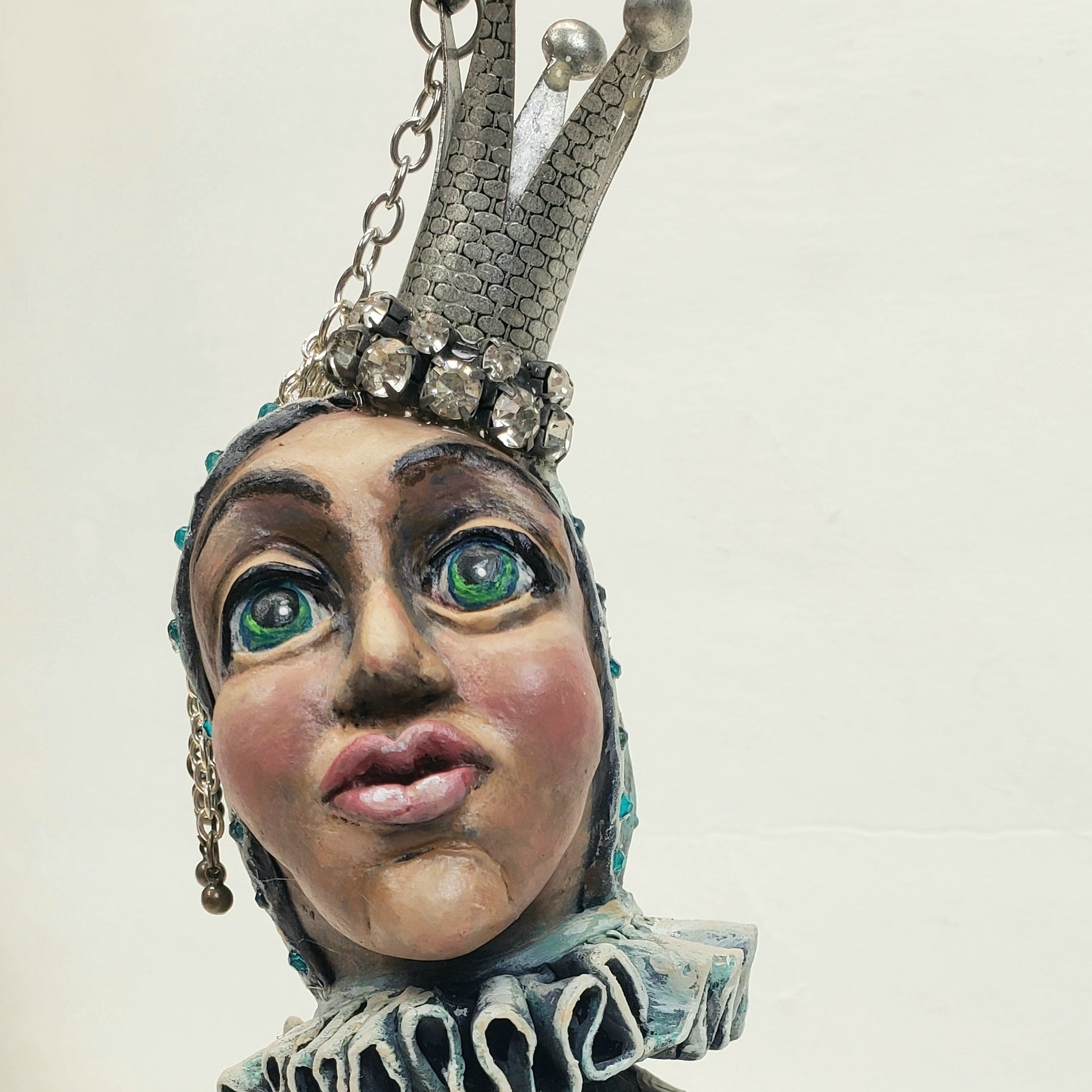 Jester figurine with a crown butterfly and patterned dress 