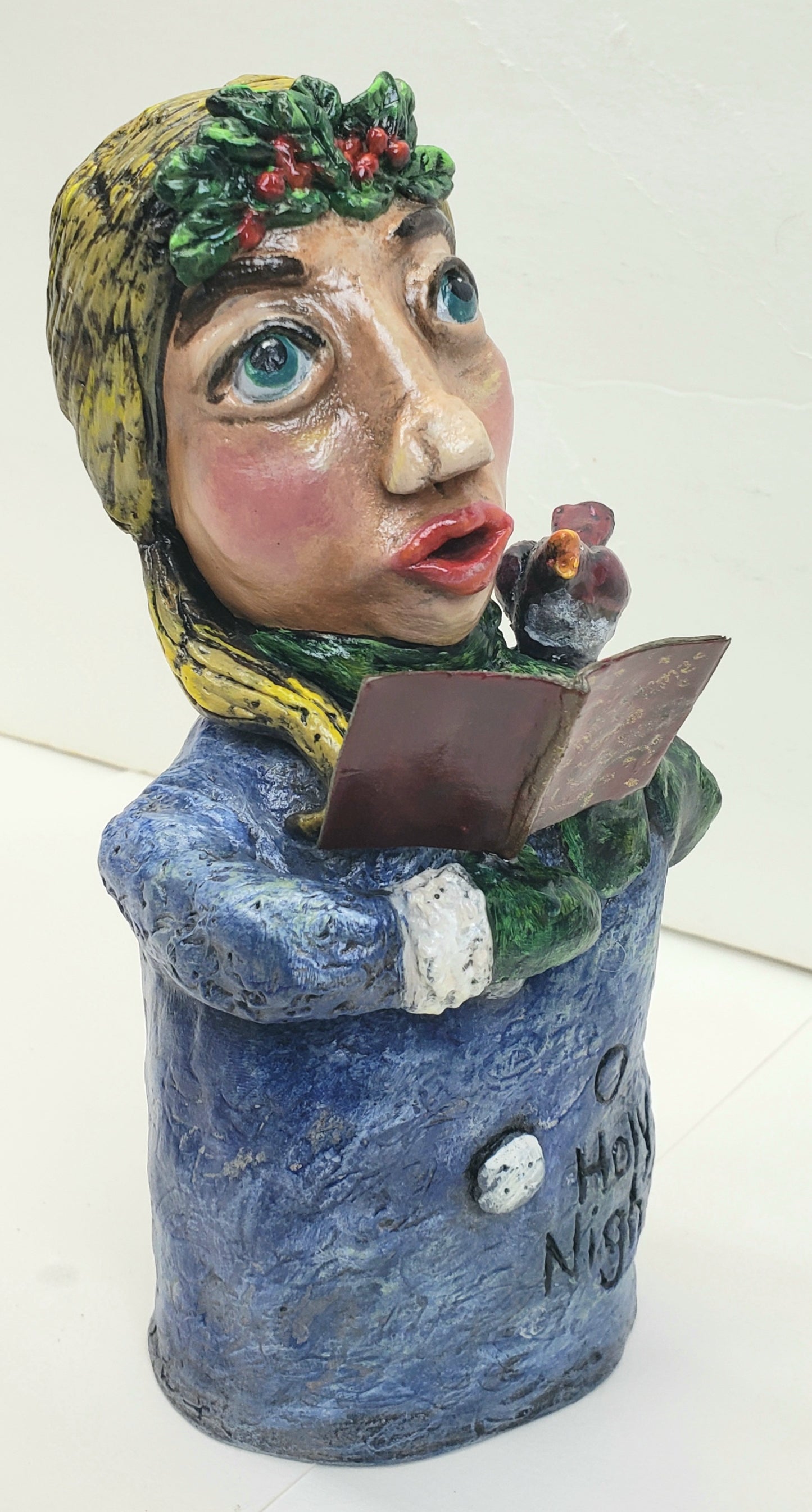 Handmade Paper clay Doll holding a christmas carols book with a bird on her shoulder  standing Christmas decoration