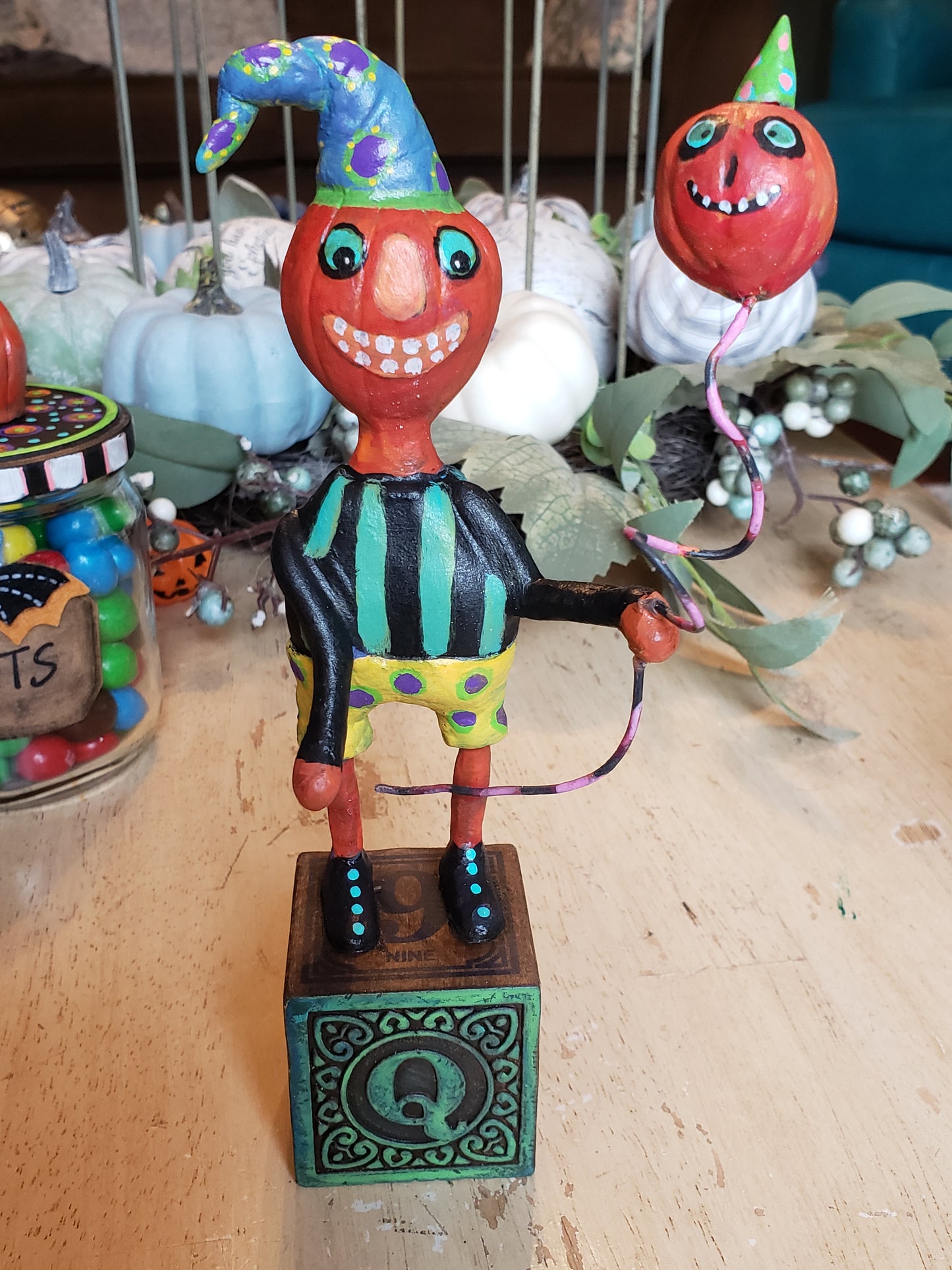 Paper clay Halloween character. A whimsical pumpkin head character holding a balloon standing on a "lettered" childs wooden block. This lil' fella is sure to become one of your favorite pieces. Whimsical, unique and OOAK

